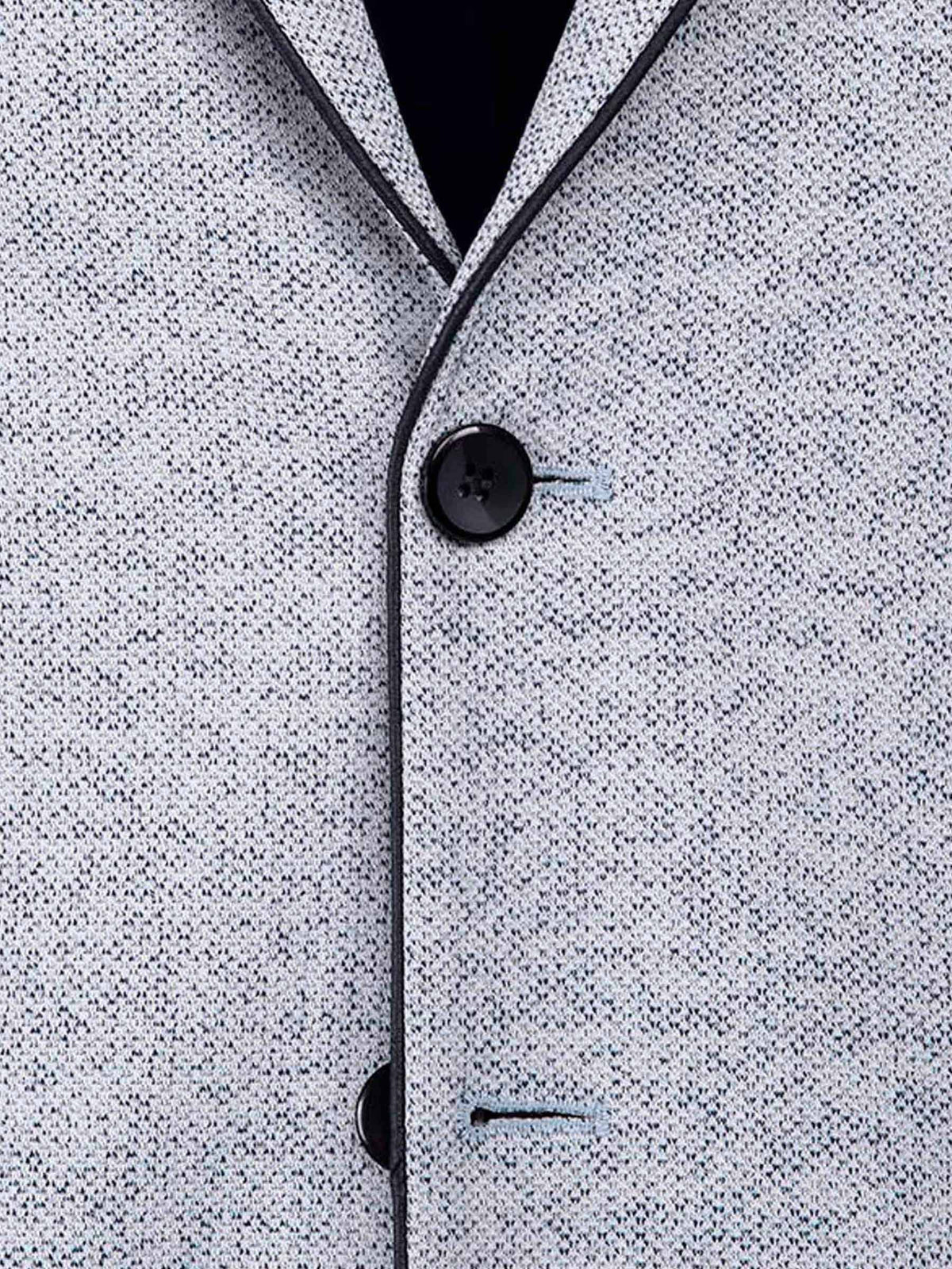 Close-up of the white-navy textured blazer fabric with dark buttons and clean stitching.