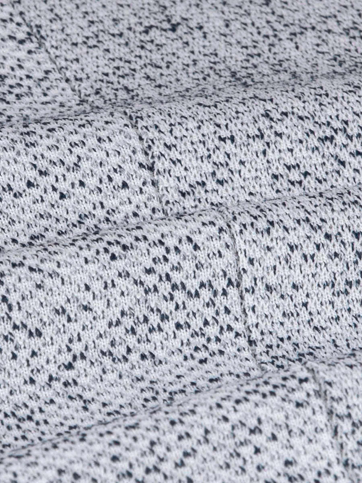 Close-up of the white-navy textured blazer fabric showing its detailed woven pattern.