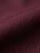 Close-up of dark red men’s shirt fabric showing smooth texture and premium weave
