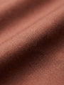 Close-up of light brown men’s shirt fabric showing smooth texture and premium weave