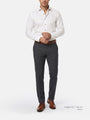 Man wearing a white shirt, gray trousers, and brown shoes on a white background