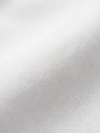 Close-up of white shirt fabric showing smooth weave and premium cotton texture.