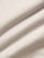 Light beige chino fabric close-up showing smooth cotton texture and premium weave.
