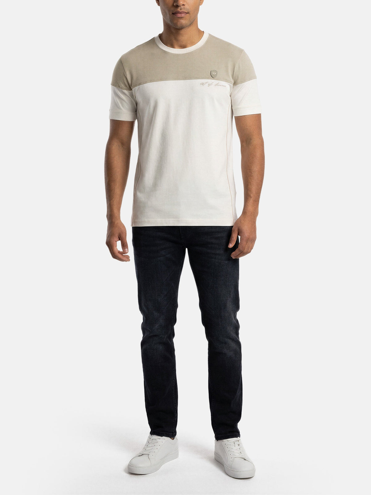 Model wearing off-white men’s T-shirt with beige chest panel, styled with dark jeans