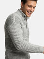 Close-up of light grey textured knit sweater with ribbed collar and panel detailing.
