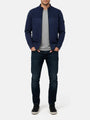 Model wearing Light Indigo full-zip men’s jacket with textured panel, styled with jeans.