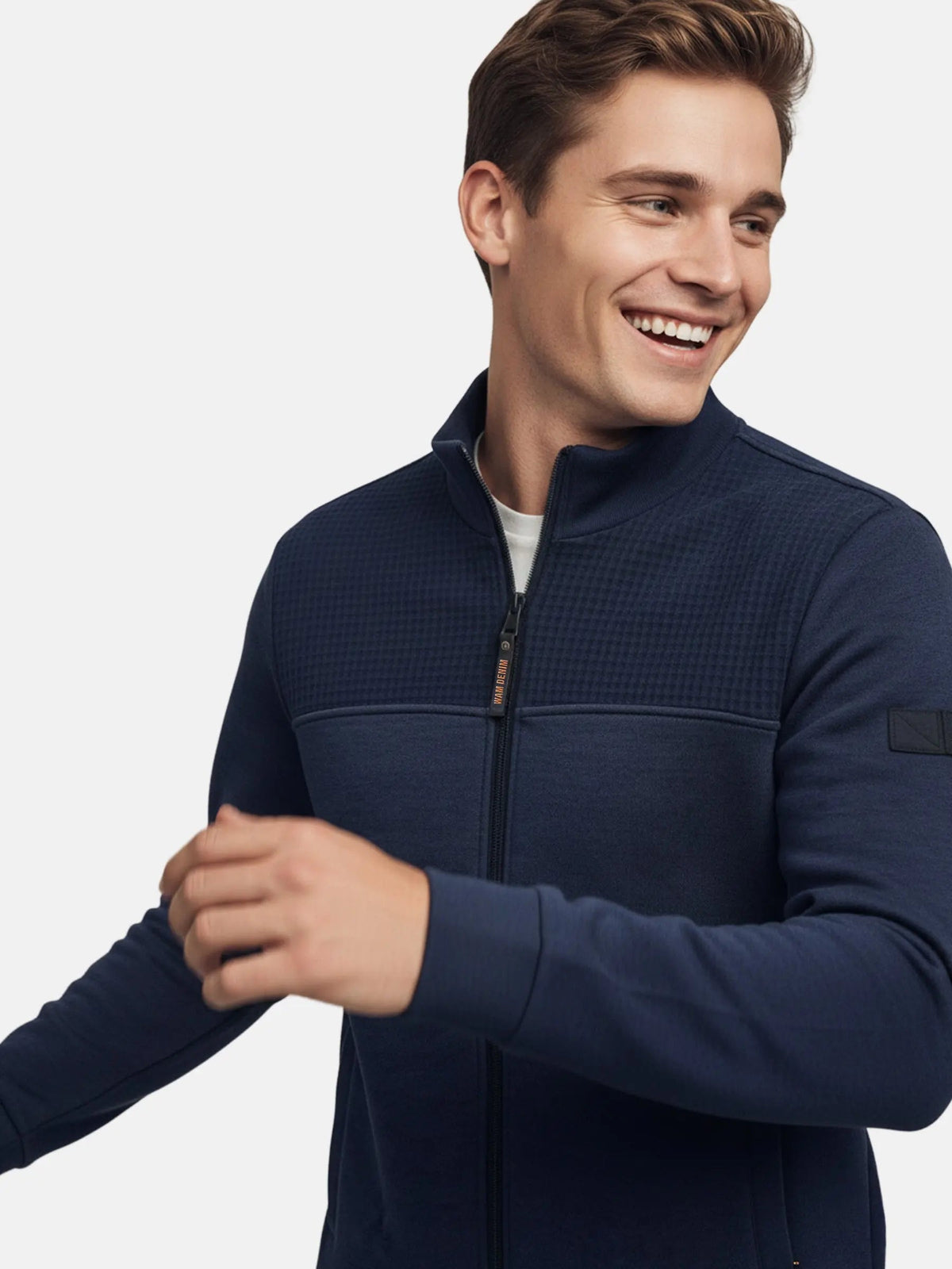 Close-up of model wearing Light Indigo full-zip men’s jacket with textured upper panel.