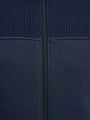 Close-up of Light Indigo jacket fabric showing textured upper panel and central zipper.