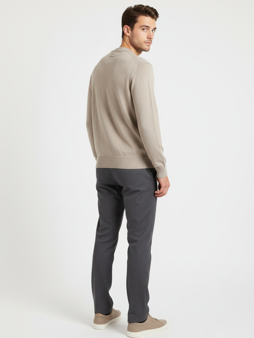 Back view of a male model wearing the Forge beige sweater with a smooth-knit back