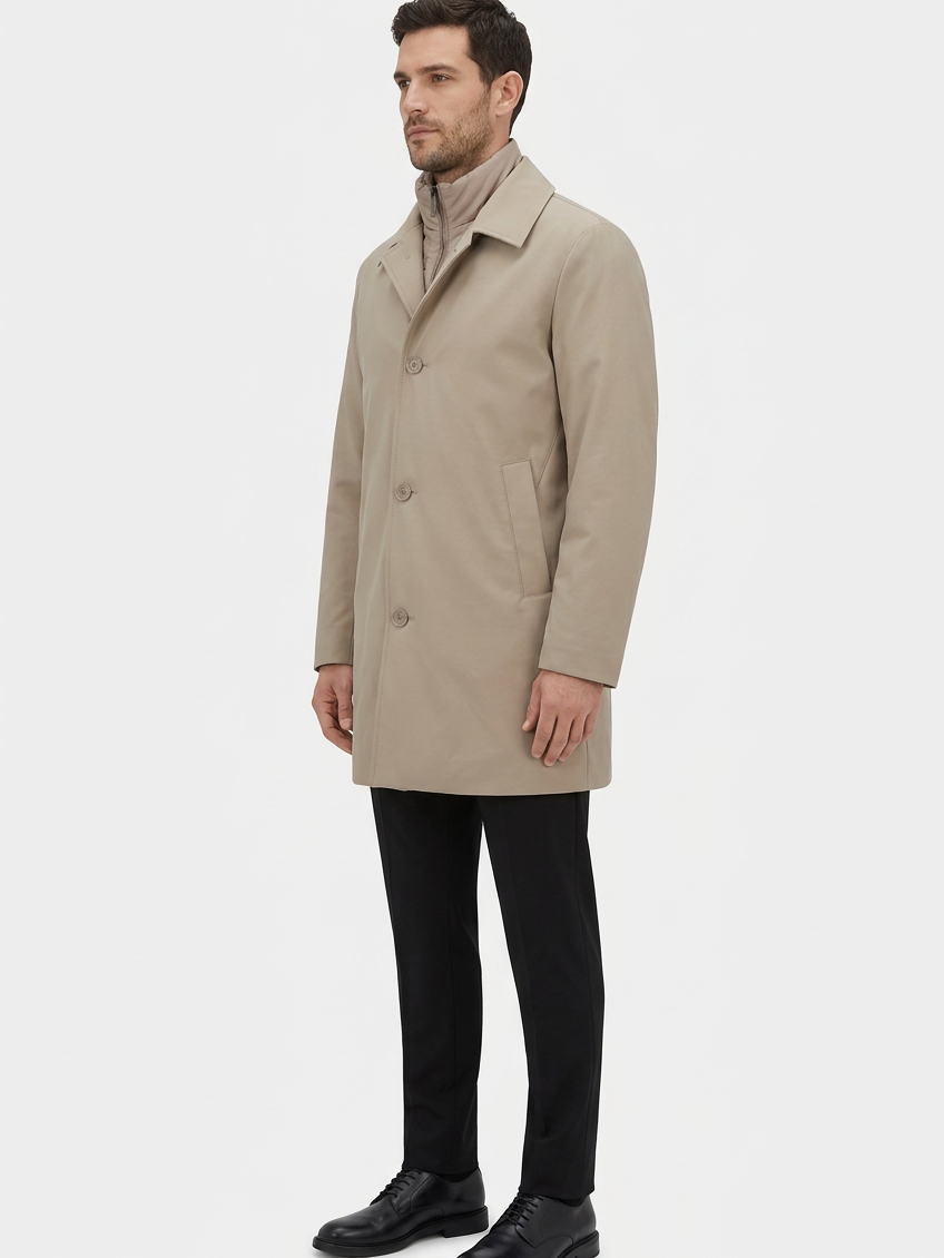 Model wearing beige coat, side view
