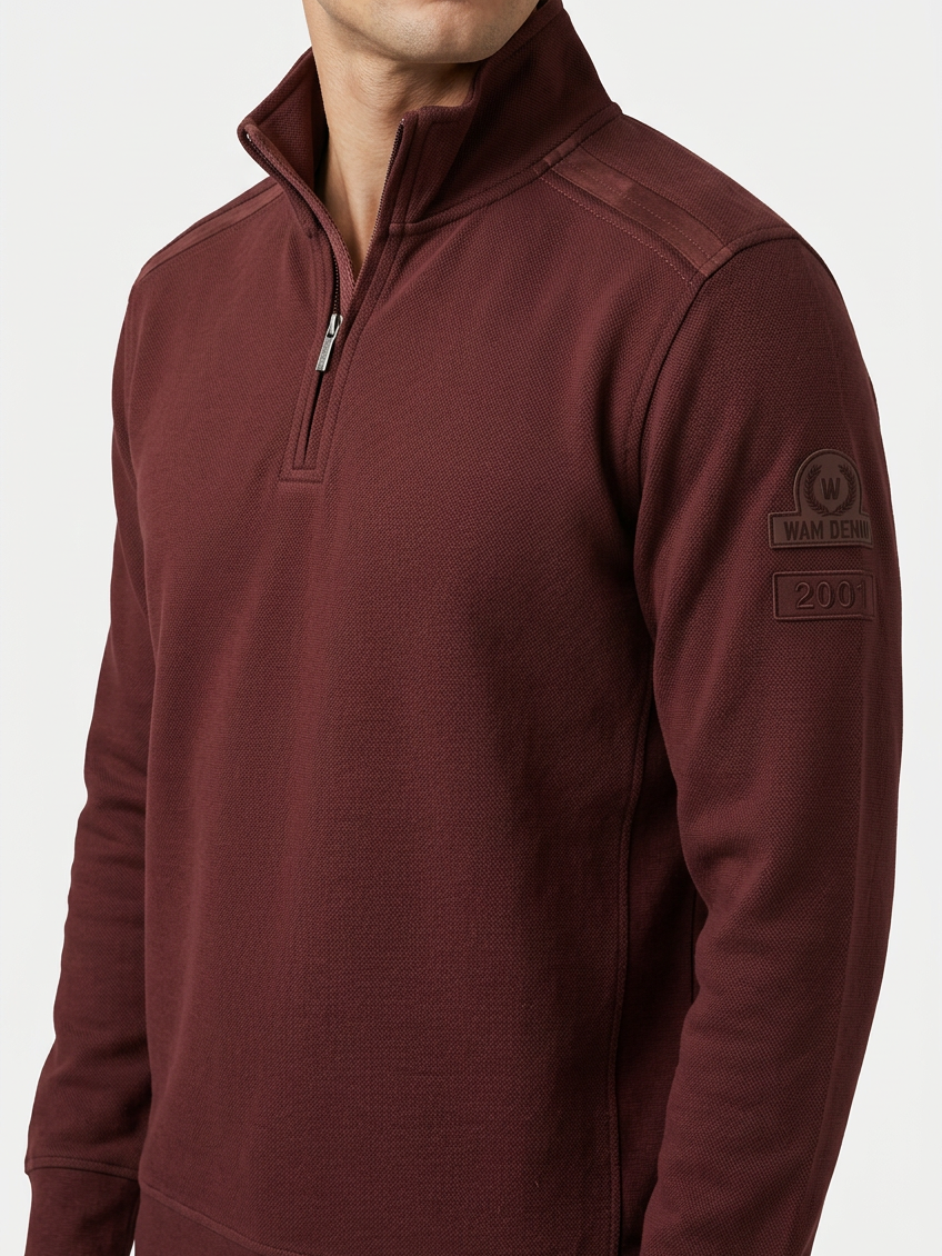 Nerik Dark Brown sweater quarter-zip and sleeve patch detail on model