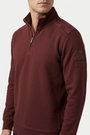 Nerik Dark Brown sweater quarter-zip and sleeve patch detail on model