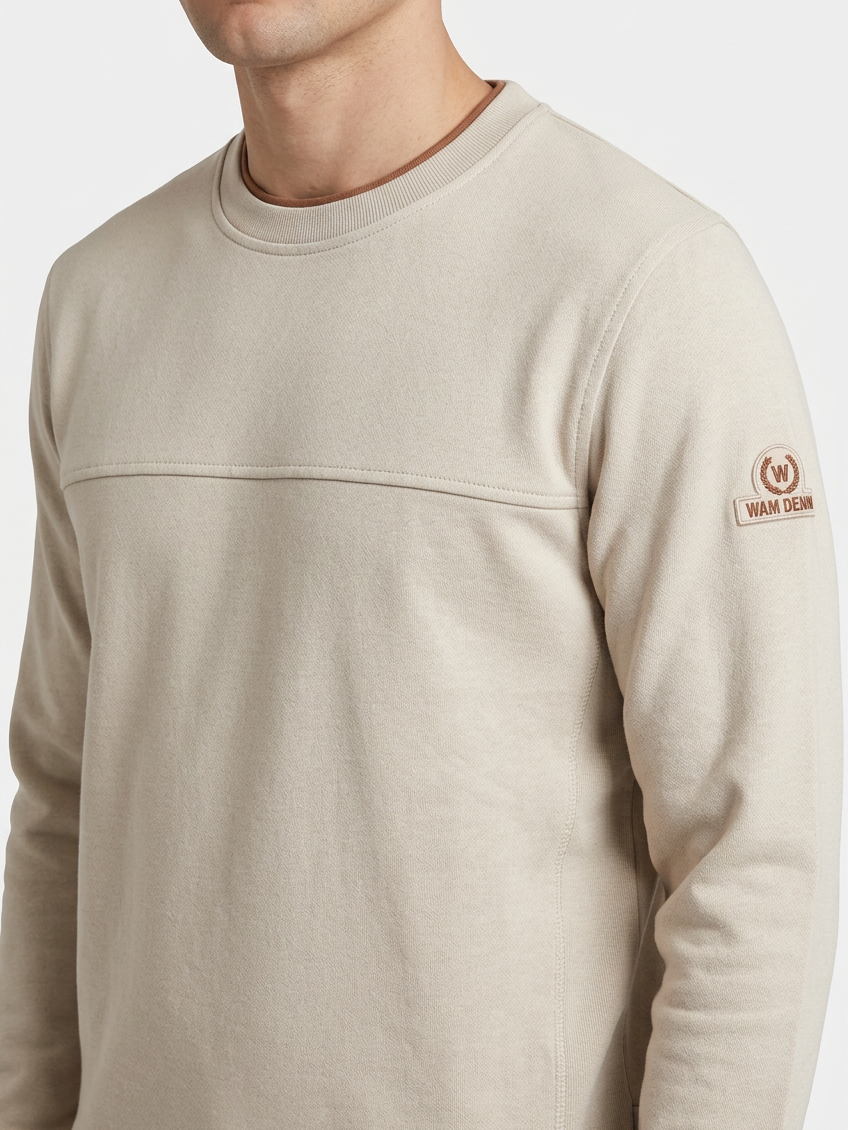 Onvik Beige sweater sleeve badge and fabric detail on model