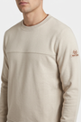 Onvik Beige sweater sleeve badge and fabric detail on model