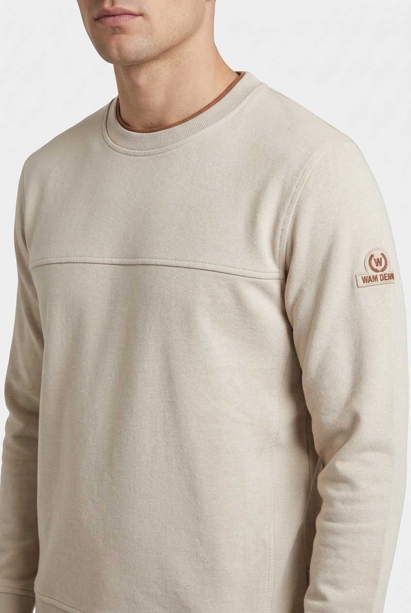 Onvik Beige sweater sleeve badge and fabric detail on model