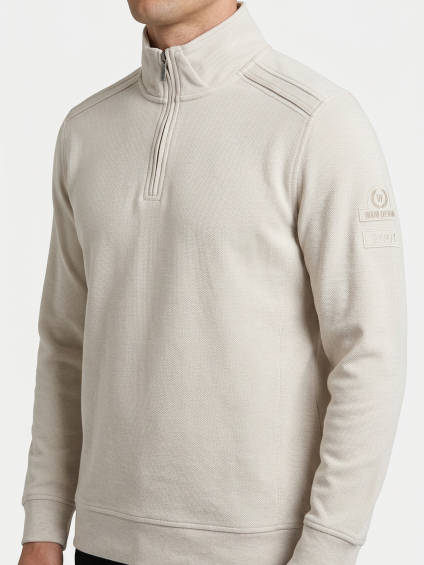 Nerik Light Beige sweater quarter-zip and sleeve patch detail on model