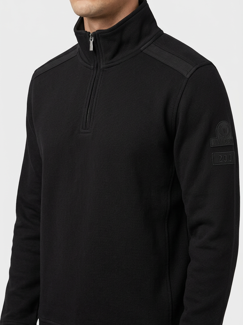 Nerik Black sweater quarter-zip and sleeve patch detail on model
