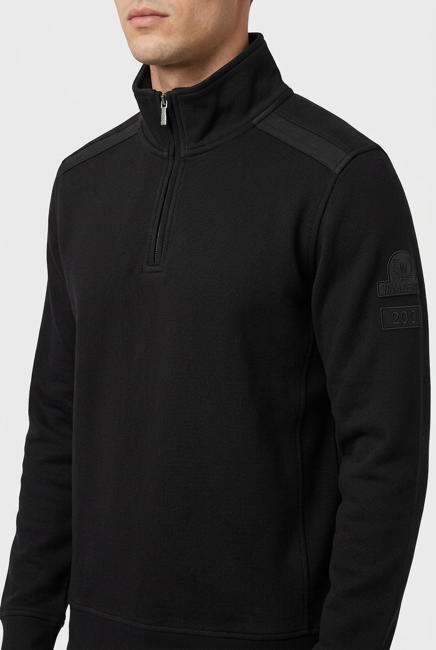 Nerik Black sweater quarter-zip and sleeve patch detail on model