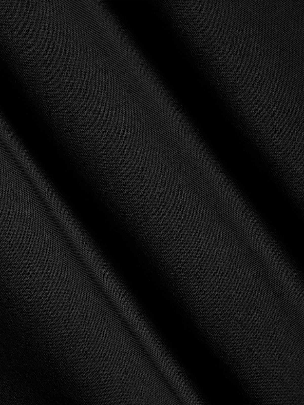Close-up of black cotton fabric texture with soft stretch finish