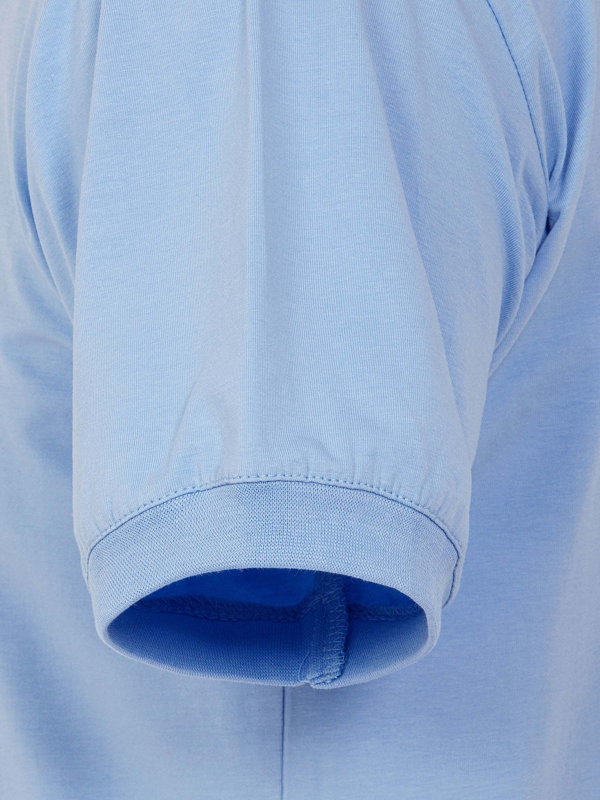 Close-up of light blue T-shirt sleeve with ribbed cuff detail