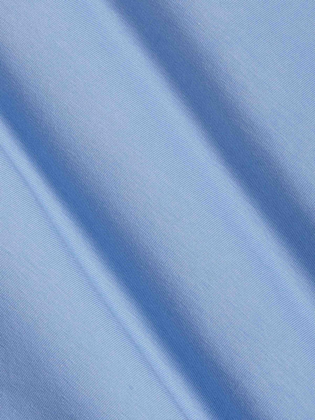 Close-up of light blue cotton fabric texture with soft stretch finish