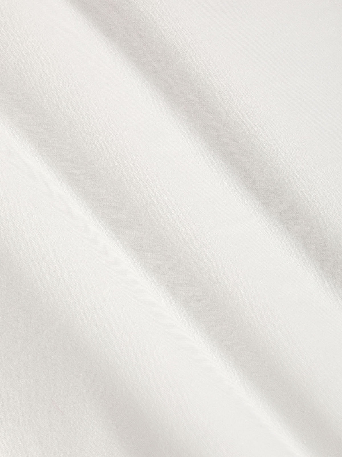 Close-up of white cotton fabric texture with smooth stretch finish
