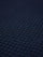 Close-up of indigo navy knit fabric showing dense textured waffle pattern.
