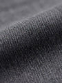 Close-up of grey denim fabric texture with fine weave detail.