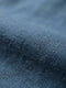 Close-up texture of blue stretch denim fabric.