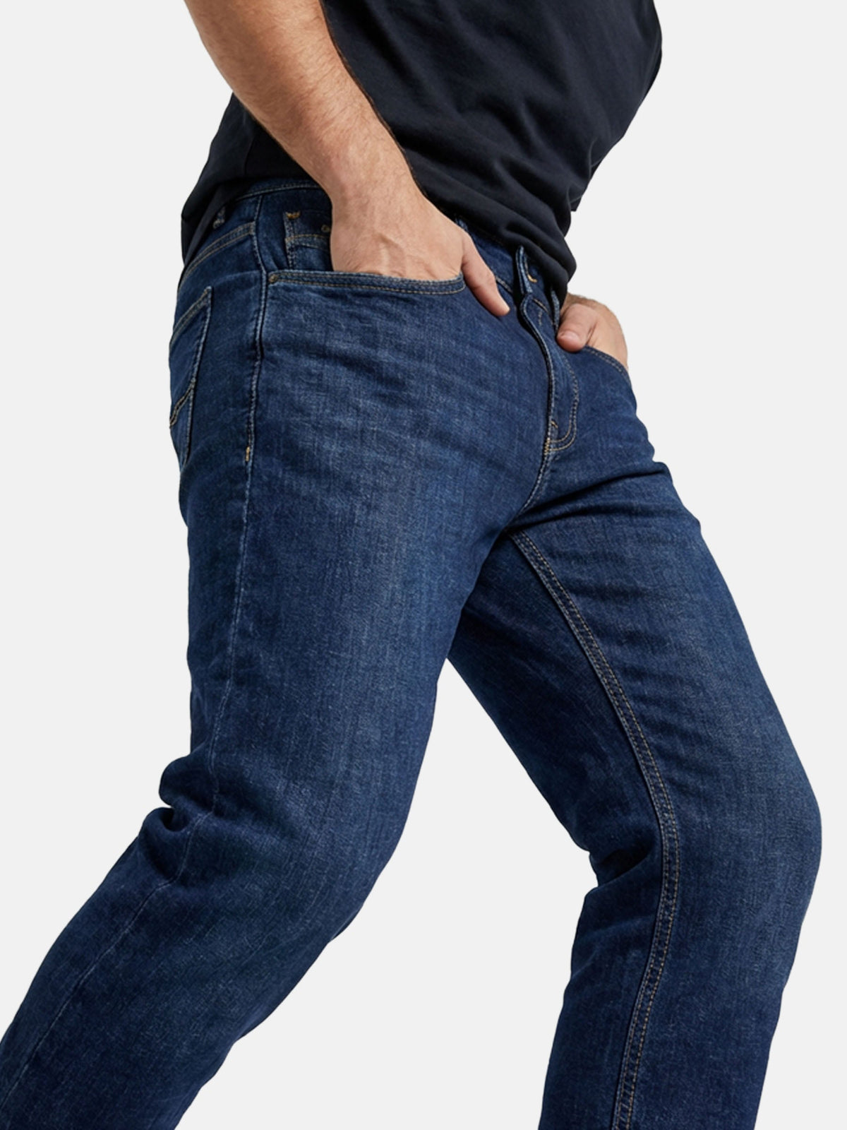 Close-up side view of blue jeans showing slim fit and stretch denim fabric