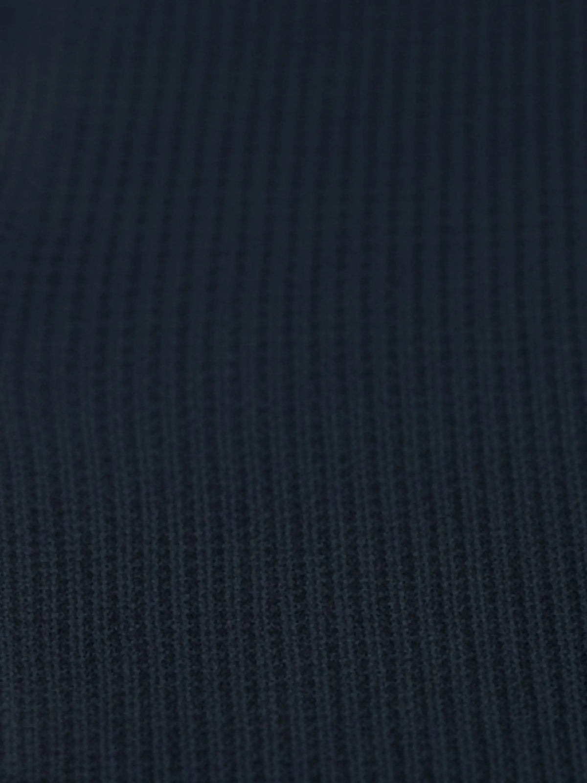 Close-up of navy textured knit fabric from the Zest Navy sweater.